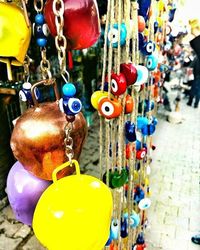 Close-up of multi colored hanging for sale in market