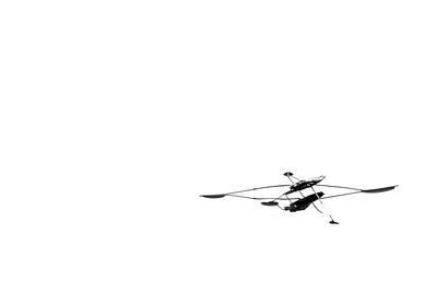 Low angle view of helicopter against clear sky