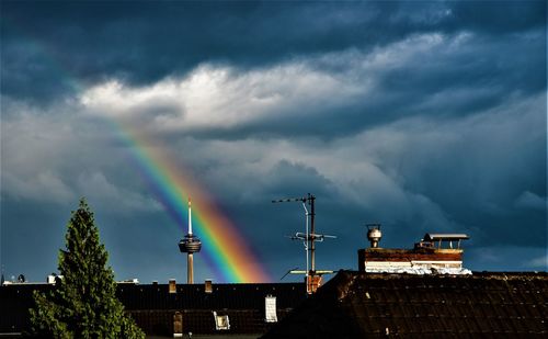 Low angle view of rainbow over buildings in city