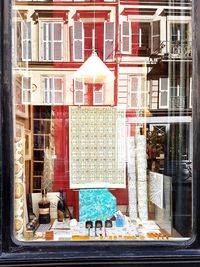 Graffiti on wall of store through window