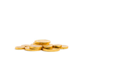 High angle view of coins on wood against white background