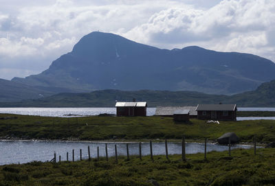 Scenic view of lake and mountains against sky