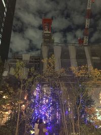 Low angle view of illuminated christmas tree at night