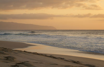 Scenic view of beach against sky during sunset