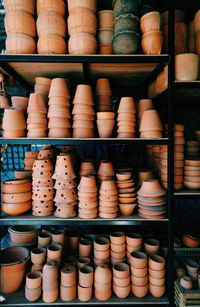 Various pots on shelves for sale in store