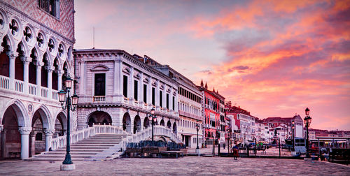 View of buildings in town against cloudy sky