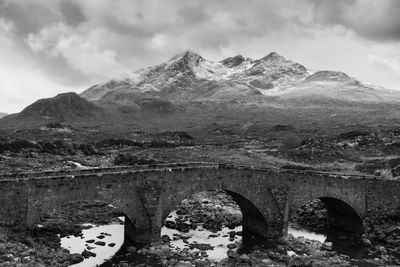 Scenic view of mountains against cloudy sky