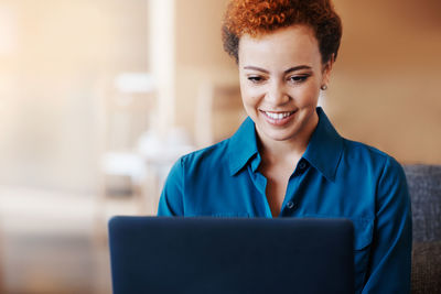Smiling businesswoman using laptop