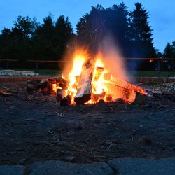 Close-up of bonfire against clear sky at night