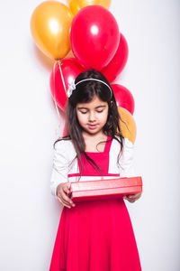 Portrait of a girl with pink balloons