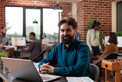 Portrait of smiling businessman at office