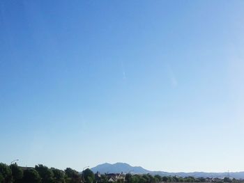 Scenic view of mountains against clear blue sky