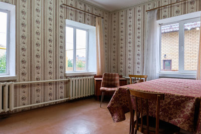 Empty chairs and table in house