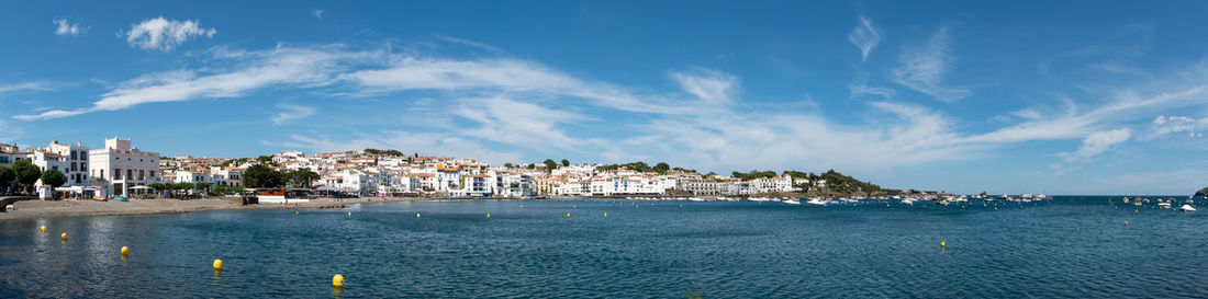 Panoramic view of sea and buildings against sky