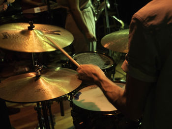 Midsection of man playing piano at music concert