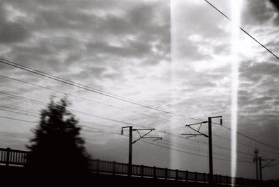 Low angle view of electricity pylon against sky