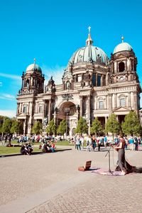 People at berlin cathedral against sky