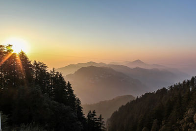 Scenic view of mountains against sky during sunset