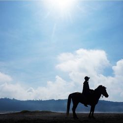 Silhouette of woman against sky