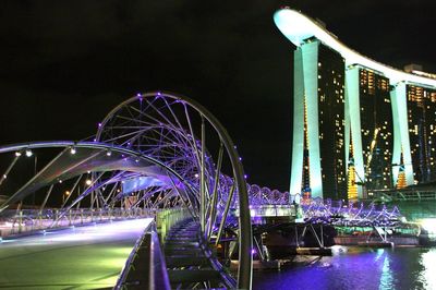 Low angle view of illuminated marina bay sands against sky at night