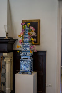 Close-up of potted plant on table against wall at home