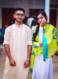 Portrait of young couple standing outdoors