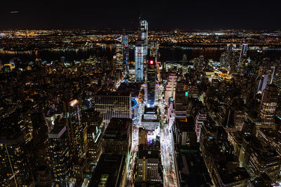 High angle view of city lit up at night