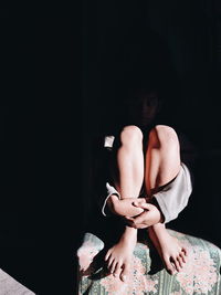 Midsection of woman sitting at home