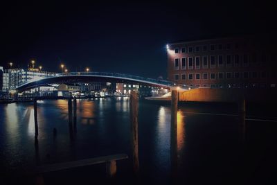 View of bridge over river at night