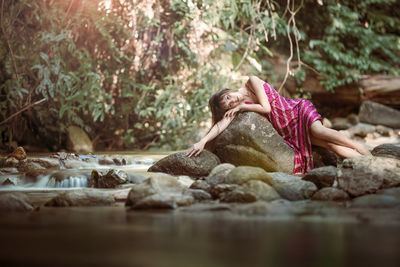 Woman relaxing on rock
