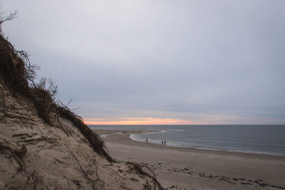 Scenic view of beach against sky during sunset