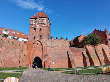 Low angle view of historic building against blue sky