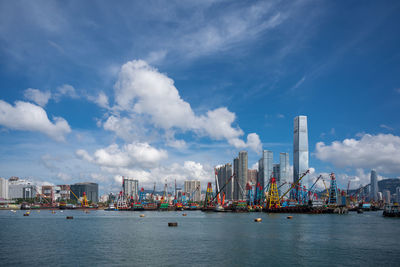 Panoramic view of harbor by sea against sky