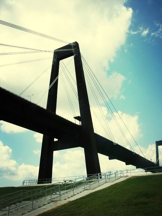 connection, bridge - man made structure, low angle view, built structure, architecture, sky, engineering, suspension bridge, bridge, cloud - sky, cloud, cable-stayed bridge, cable, transportation, support, day, outdoors, no people, cloudy, steel cable