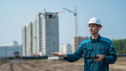 Engineer standing against clear sky