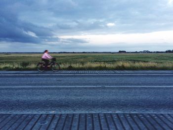 Man riding bicycle on road