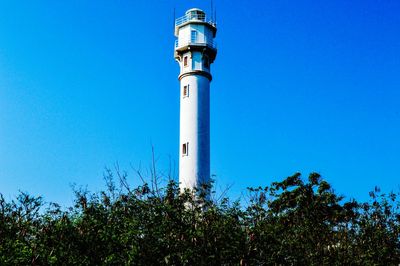 Low angle view of lighthouse against clear blue sky