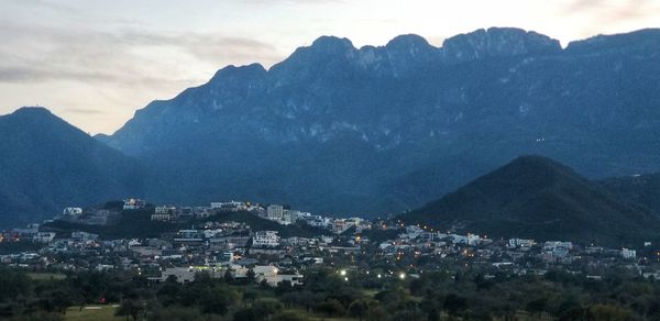 High angle view of townscape and mountains against sky