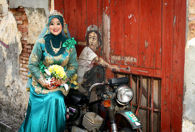 Optical illusion of bride sitting with man drawn at door on motorcycle