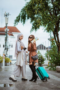 Portrait of woman standing in city