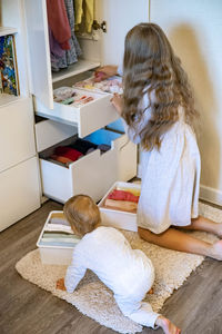 Cute girl sitting on floor at home