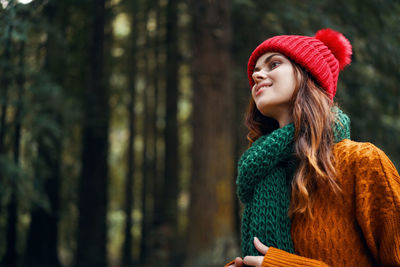 Beautiful young woman looking away outdoors