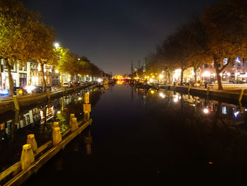 Reflection of illuminated city in water at night