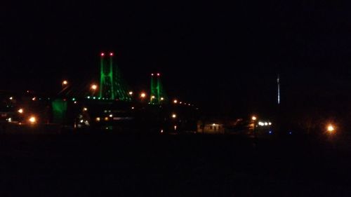 Illuminated city against sky at night