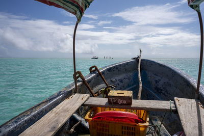 Fishing boat in sea against sky