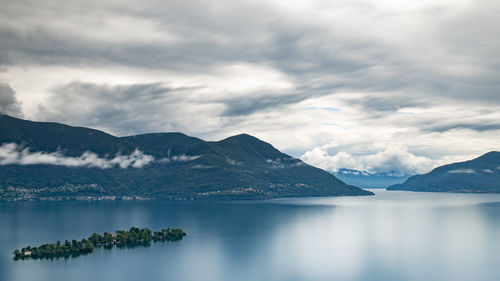 Scenic view of sea and mountains against sky