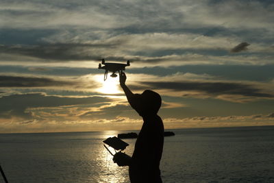 A drone pilot taking a video of the sunset on the alafan beach in simeulue district