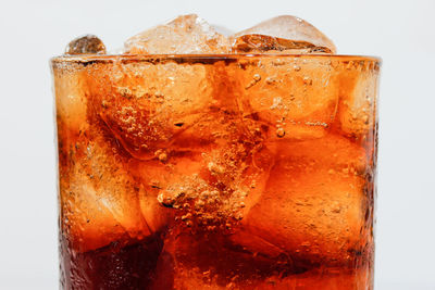 Close-up of beer on glass against white background