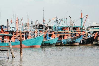 Boats moored at sea against clear sky