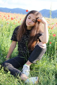 Beautiful young woman wearing sunglasses on field